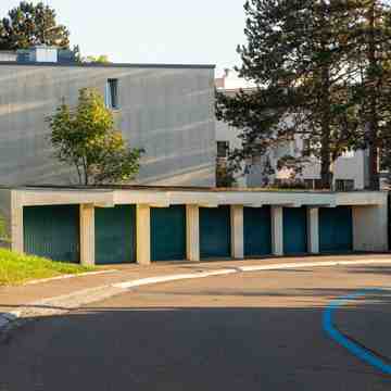 A row of residential garage doors on a low building.